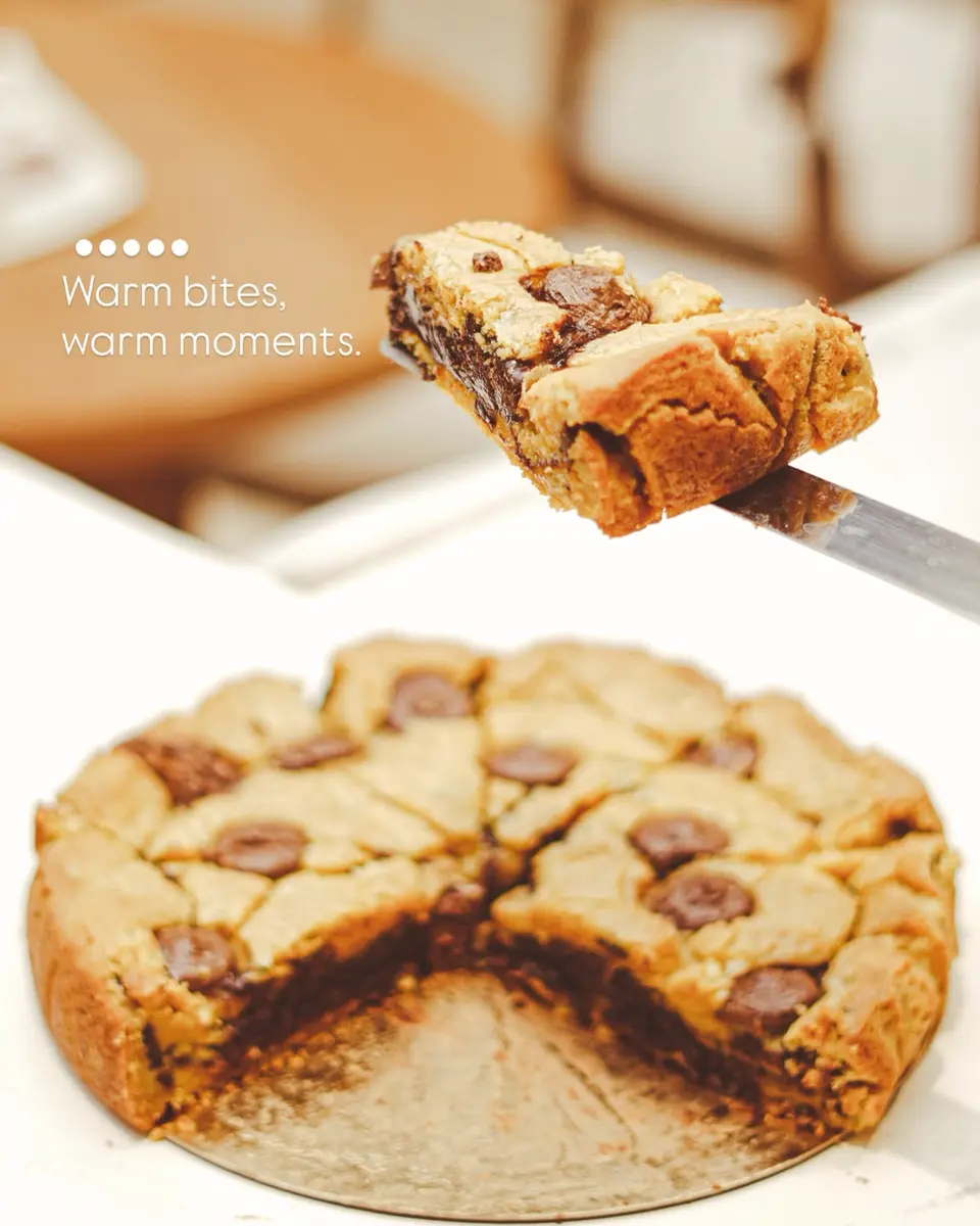 Warm Lamoge chocolate chip blondie lifted from a freshly baked tray